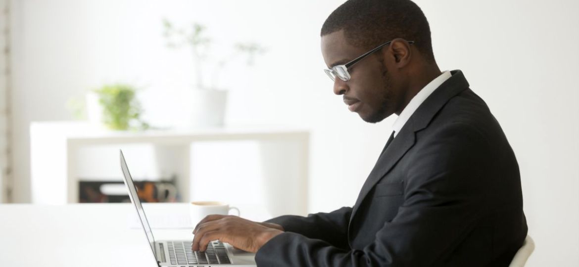 Man sitting at computer writing a rejection letter