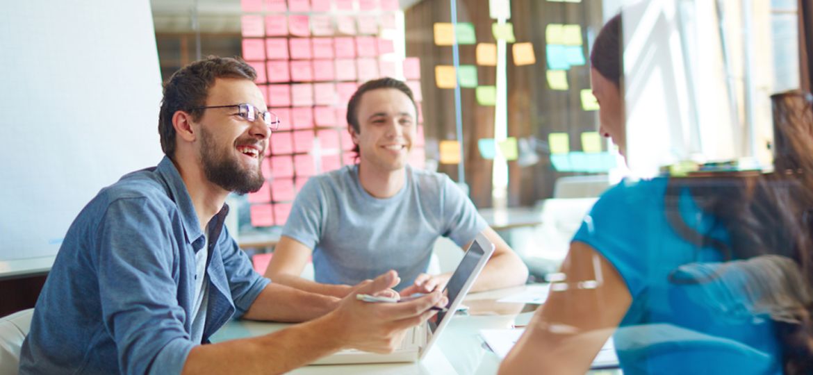 colleagues in office around table strategizing ways to recruit hourly employees
