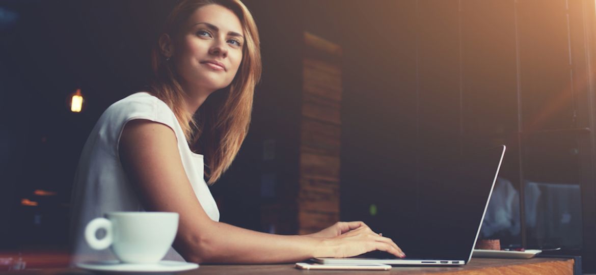 Successful woman in HR career working on laptop in modern workplace