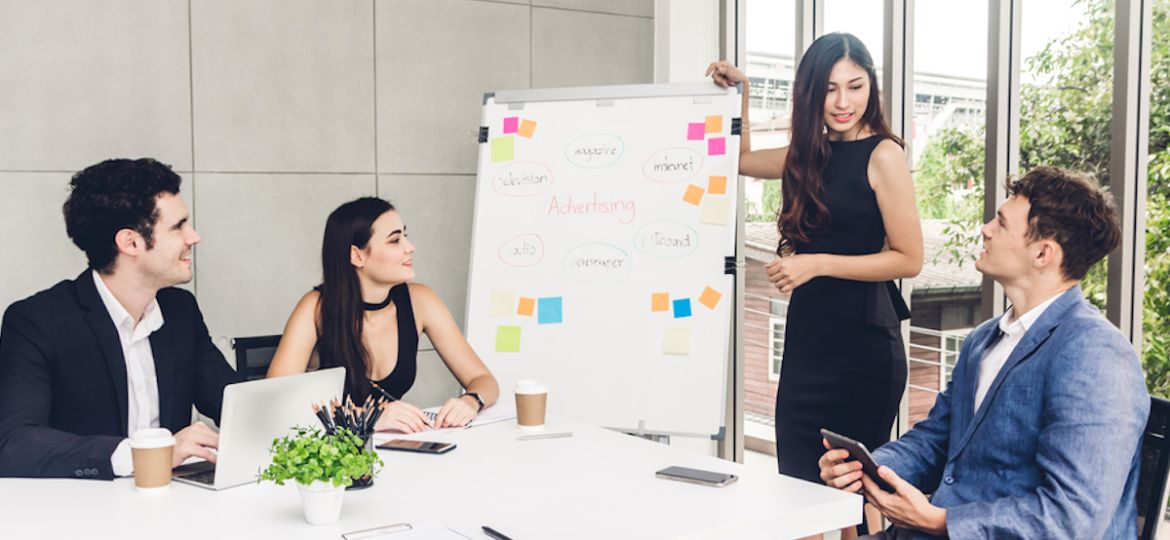 Business people planning and brainstorming social media employee engagement strategy in modern workloft