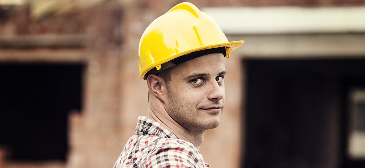 Man in construction hat and text about construction labor shortage