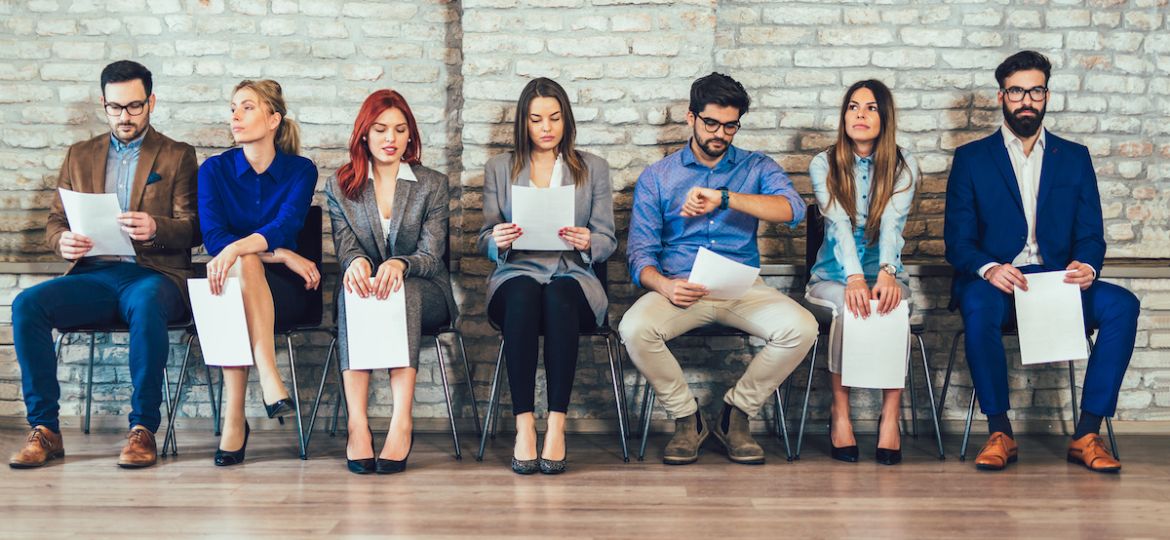 candidates sitting in waiting room on mobile devices