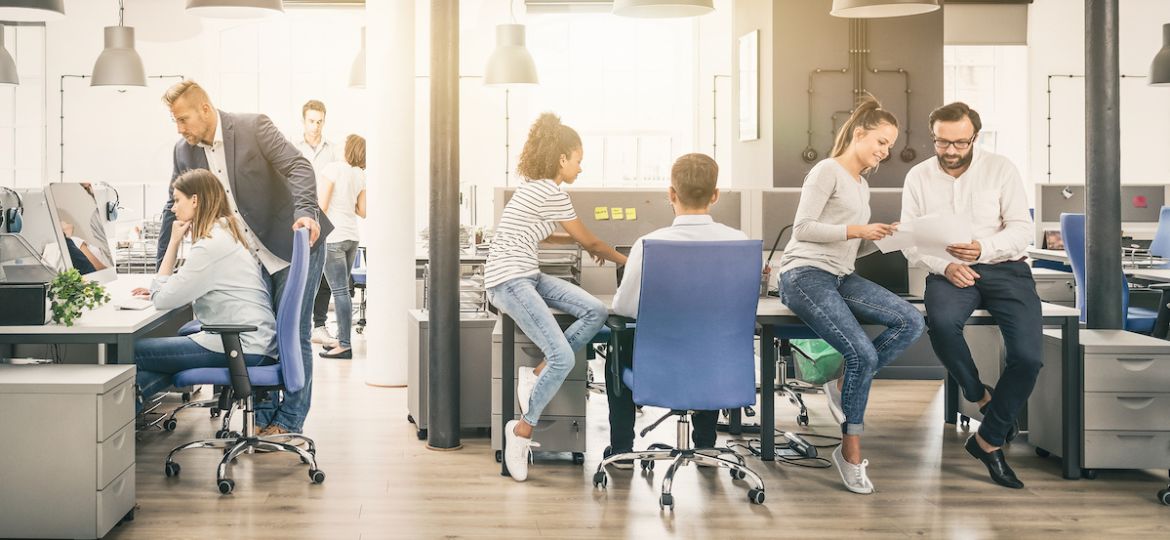 Group of young business people working together in modern office, overcoming HR challenges.