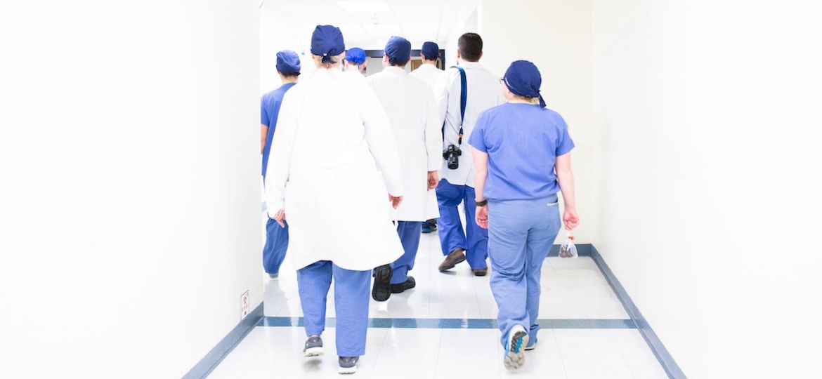 group of healthcare professionals walking down the halls of their new hospital after being a job candidate.