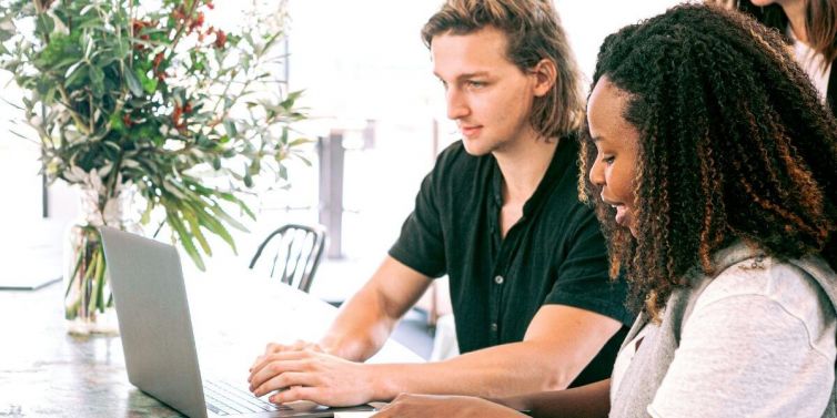 Man and woman looking at laptop