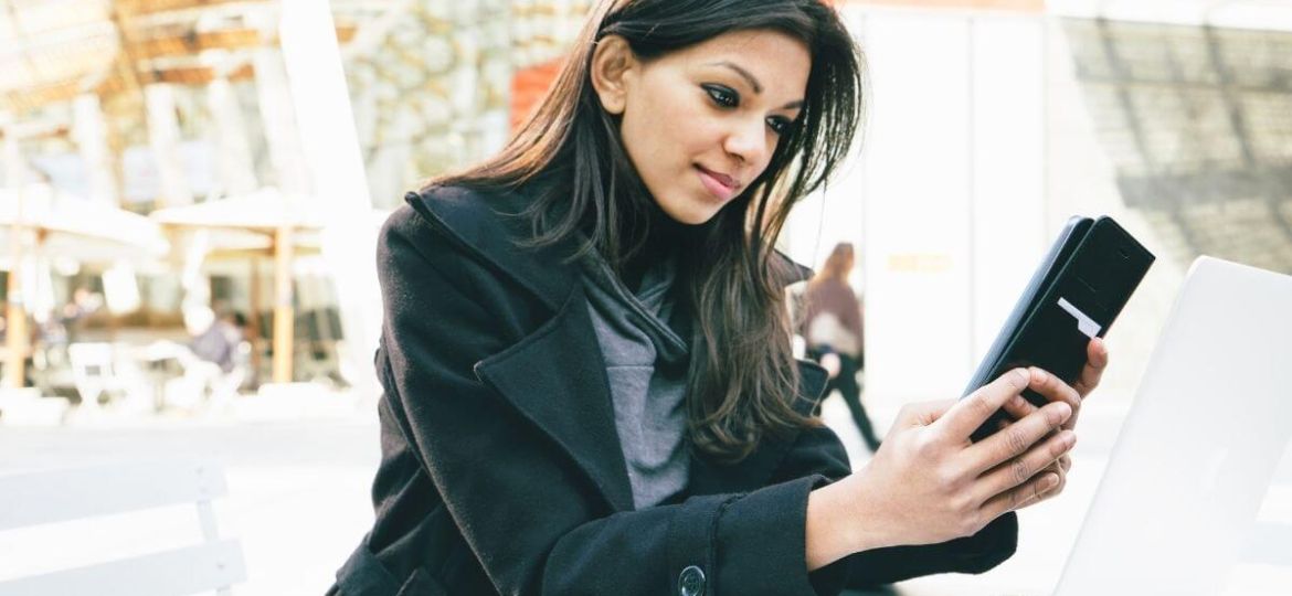 Young woman watching videos on her mobile phone