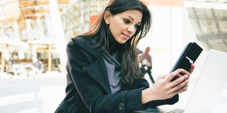 Young woman watching videos on her mobile phone