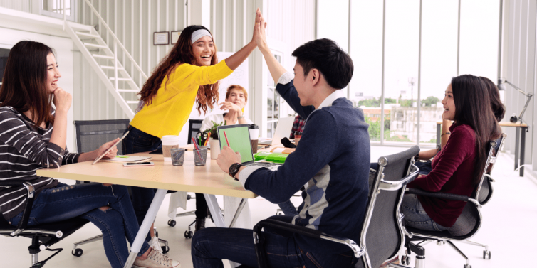 Group of employees sitting around a conference table for Employee Appreciation Week